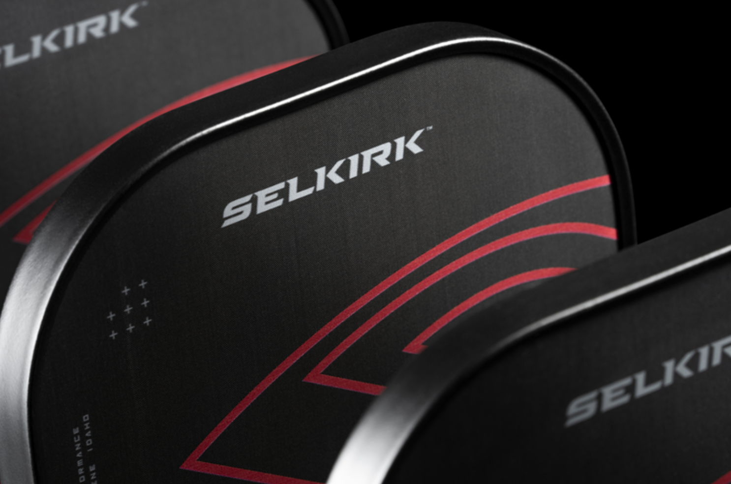 A close-up image shows the tops of Selkirk LABS Project 008 pickleball paddle. 